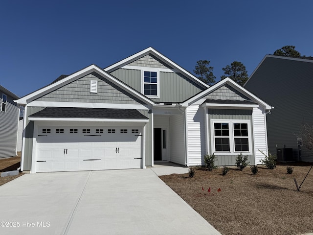 view of front of house featuring board and batten siding, driveway, and a front yard