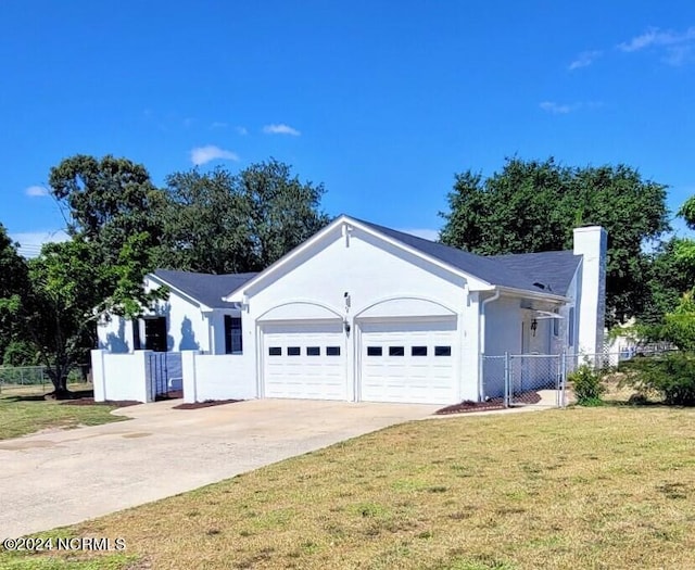 ranch-style home with a front lawn and a garage