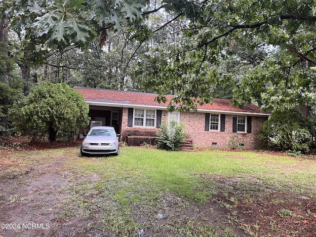 ranch-style house featuring crawl space, brick siding, a carport, and a front yard