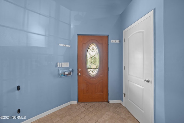 foyer featuring baseboards