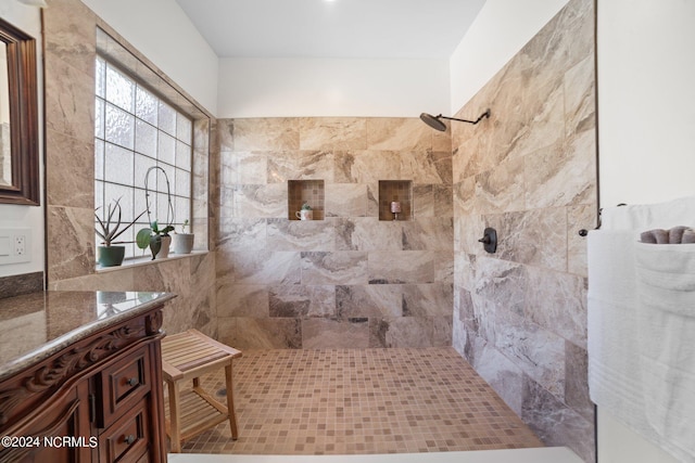 bathroom with a tile shower