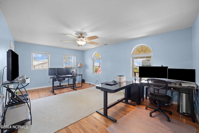 office space featuring a ceiling fan, hardwood / wood-style flooring, and baseboards