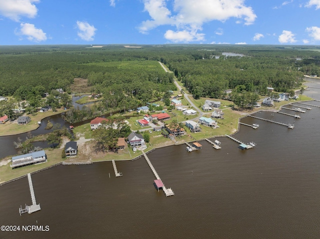 aerial view with a water view and a wooded view