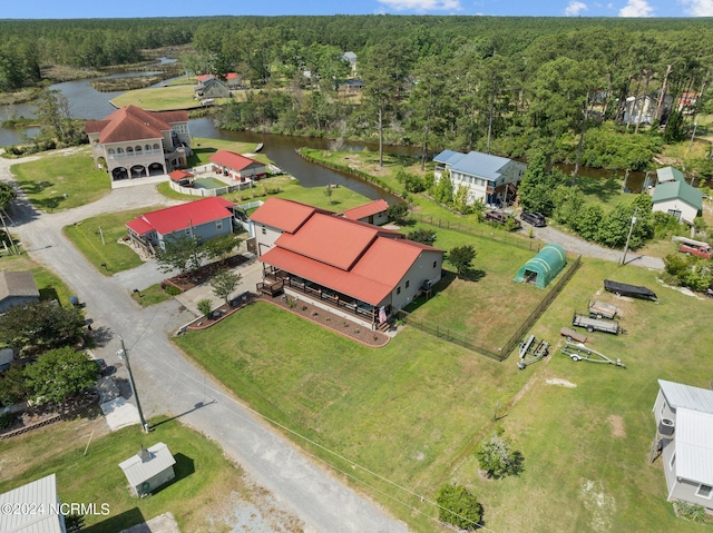 birds eye view of property featuring a water view and a view of trees