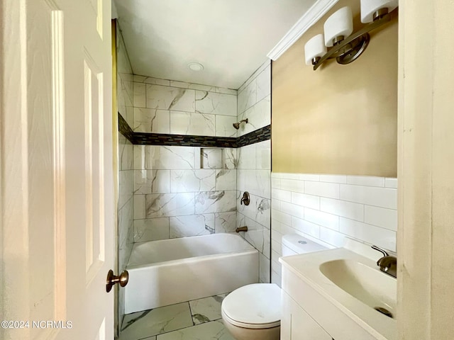 full bathroom featuring crown molding, toilet, vanity, tile walls, and tiled shower / bath