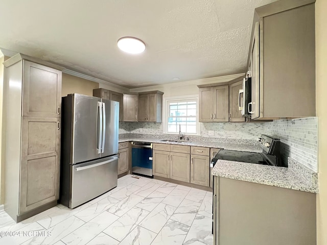 kitchen with backsplash, ornamental molding, sink, and appliances with stainless steel finishes