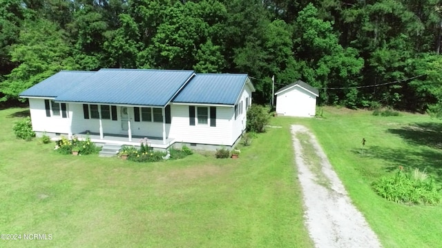 exterior space with a porch and a front yard