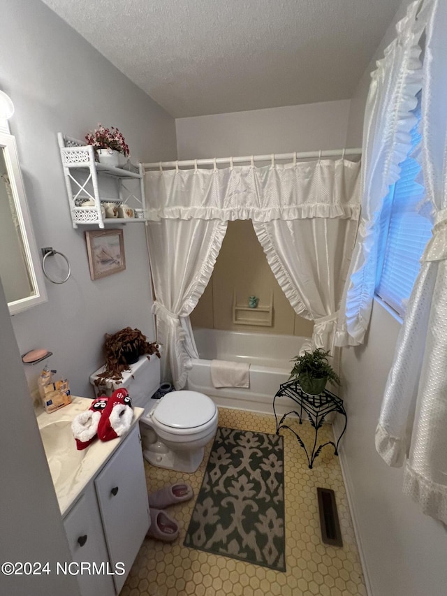 full bathroom featuring vanity, toilet, a textured ceiling, and shower / tub combo with curtain