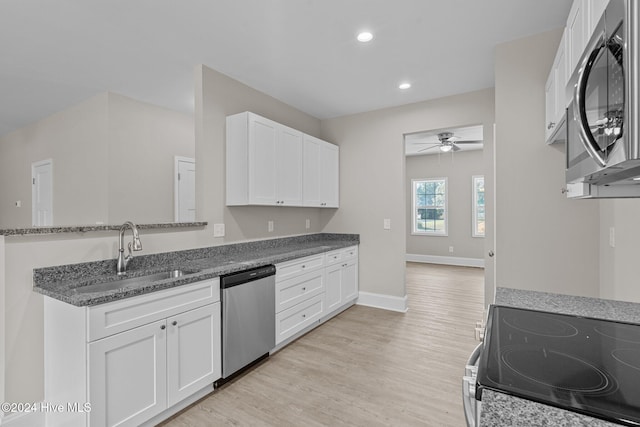 kitchen with white cabinetry, sink, light wood-type flooring, and appliances with stainless steel finishes