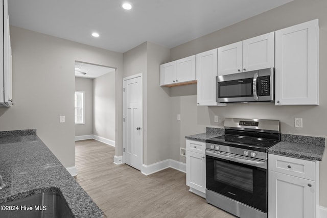 kitchen with appliances with stainless steel finishes and white cabinets