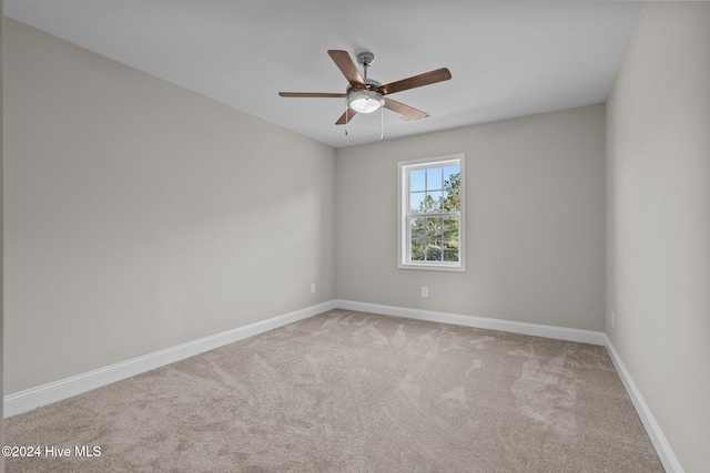 spare room featuring ceiling fan and carpet flooring