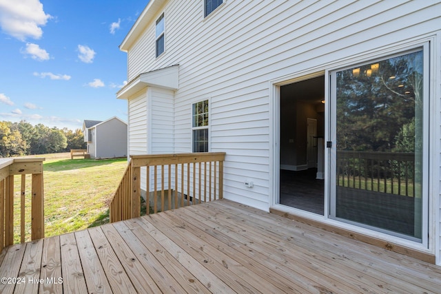 wooden terrace with a lawn