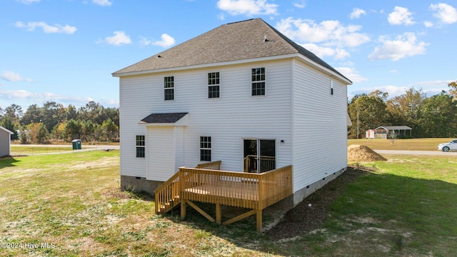 rear view of property featuring a lawn and a wooden deck