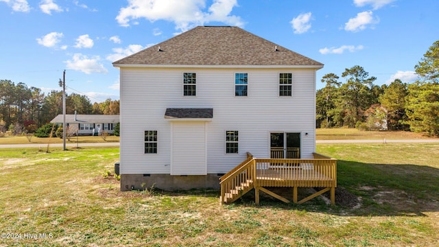 rear view of house featuring a lawn and a wooden deck