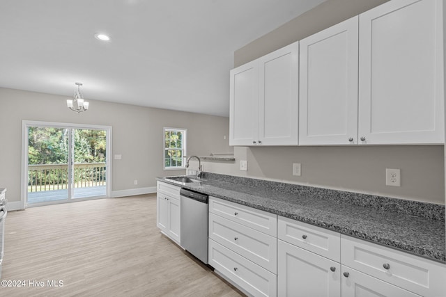 kitchen with light hardwood / wood-style flooring, stainless steel dishwasher, sink, and white cabinets