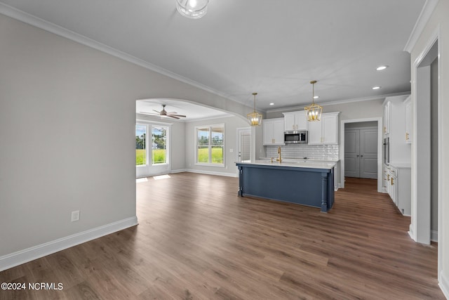 kitchen featuring dark hardwood / wood-style flooring, pendant lighting, blue cabinetry, ceiling fan, and white cabinets