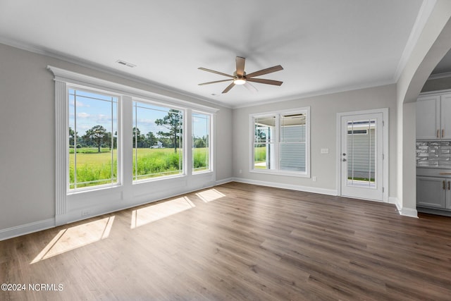 unfurnished living room with ornamental molding, dark wood-type flooring, and ceiling fan