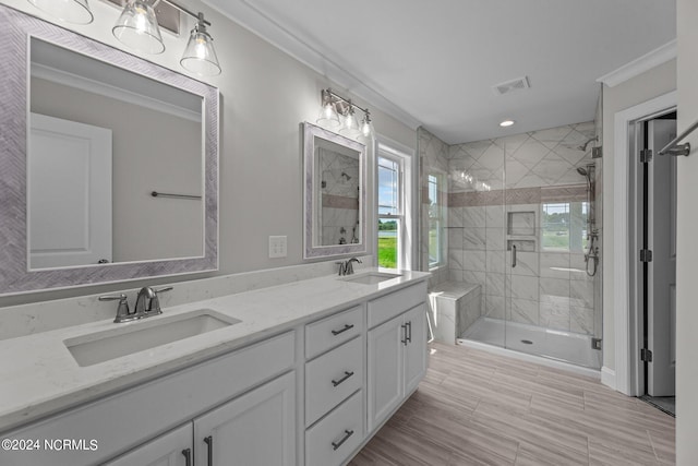 bathroom with vanity, ornamental molding, and an enclosed shower