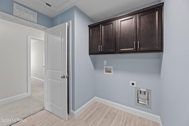 clothes washing area featuring hookup for a washing machine, cabinets, hookup for an electric dryer, and hardwood / wood-style flooring