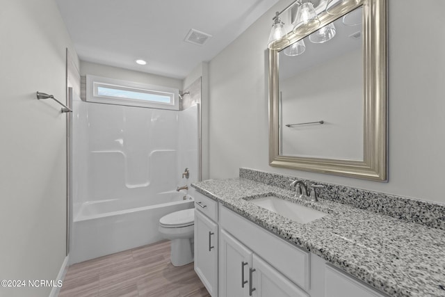 full bathroom with shower / bathtub combination, toilet, hardwood / wood-style flooring, and vanity