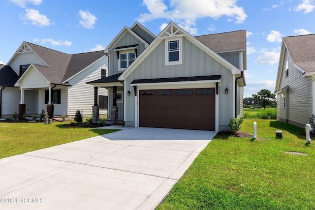 craftsman house featuring a front yard and a garage