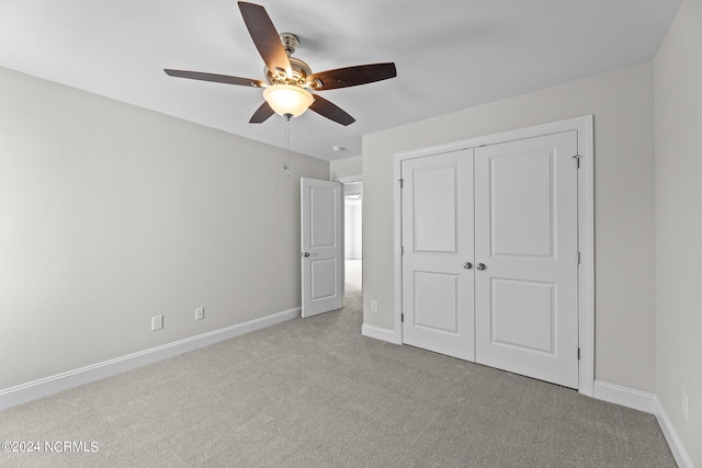 unfurnished bedroom with a closet, ceiling fan, and light colored carpet