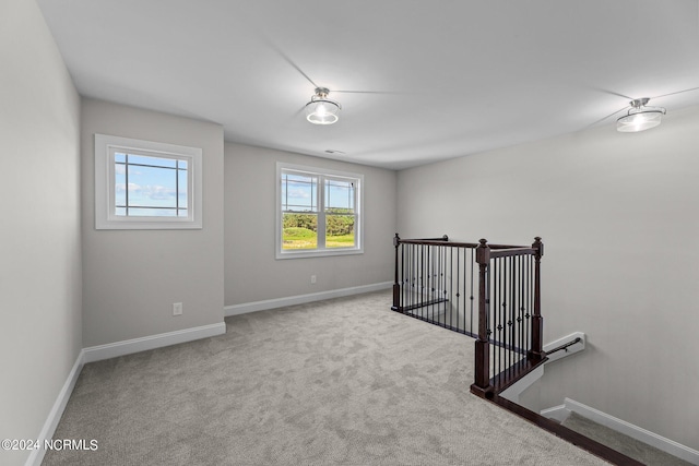 carpeted empty room with a baseboard radiator