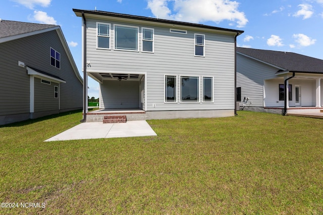 rear view of house with a yard and a patio