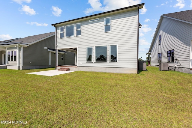 rear view of property with a patio area, a yard, and cooling unit