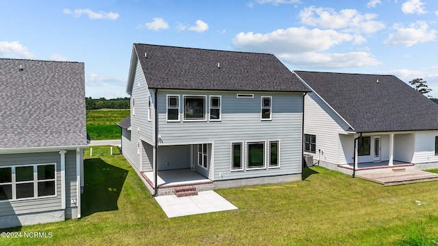 rear view of property with a yard and a patio area