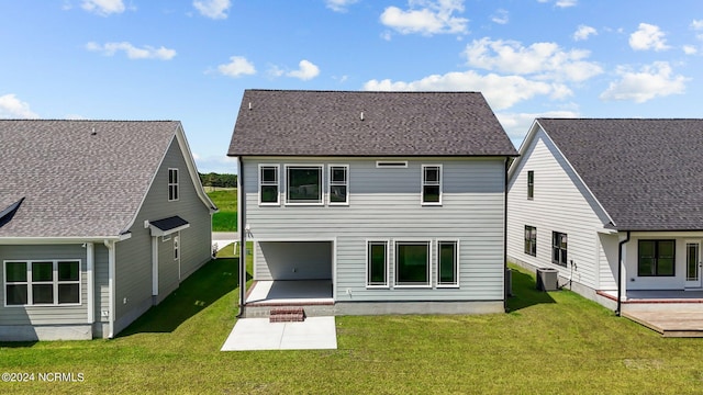 back of house with a lawn, a patio area, and central air condition unit