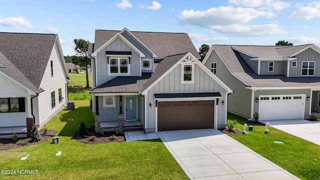 view of front of house featuring a garage, a front lawn, and central air condition unit