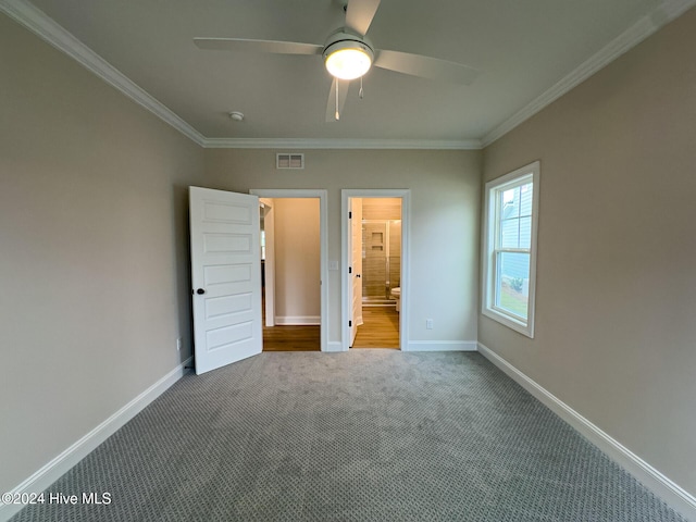 unfurnished bedroom with ceiling fan, carpet, ensuite bathroom, and crown molding