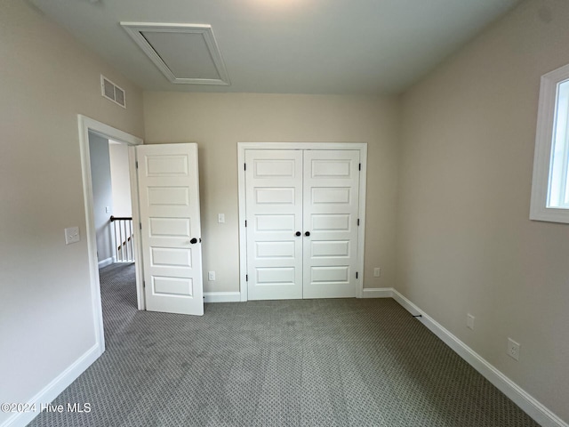 unfurnished bedroom with a closet and carpet flooring