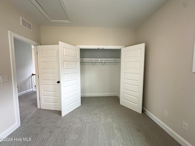 unfurnished bedroom with carpet floors and a closet