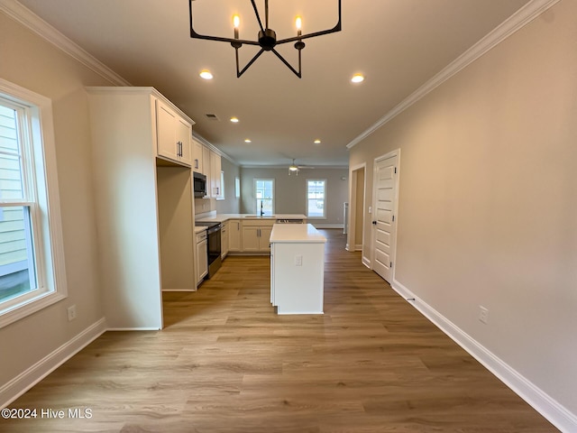 kitchen featuring white cabinetry, ornamental molding, light hardwood / wood-style flooring, and electric range