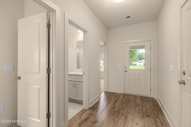 doorway with dark hardwood / wood-style floors