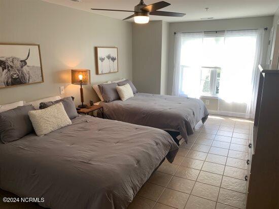 bedroom with ceiling fan and tile floors