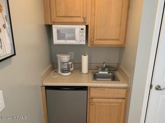 kitchen with sink and stainless steel dishwasher