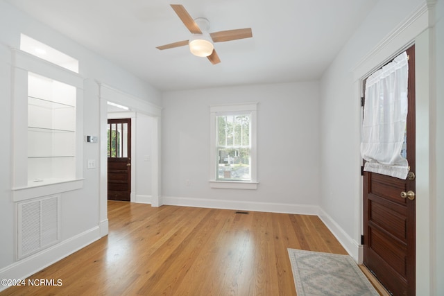 foyer with ceiling fan and light wood-type flooring