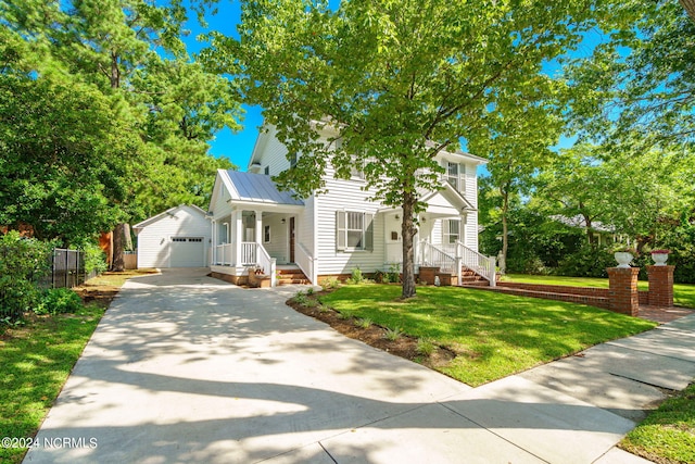 view of front of property featuring a front yard, a garage, and an outdoor structure