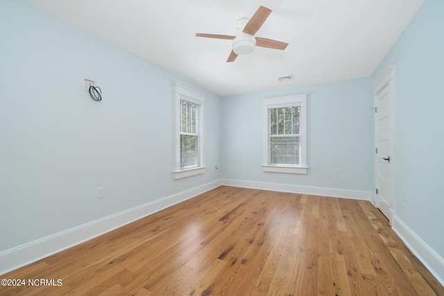 spare room with ceiling fan and light wood-type flooring