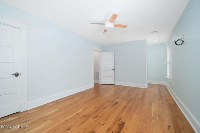 empty room featuring ceiling fan and light hardwood / wood-style floors