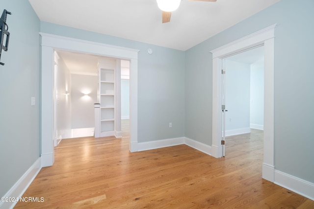 empty room with light wood-type flooring and ceiling fan