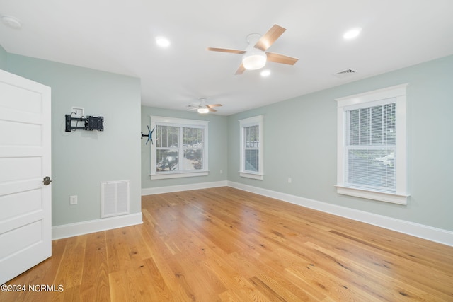 spare room with ceiling fan and light hardwood / wood-style flooring