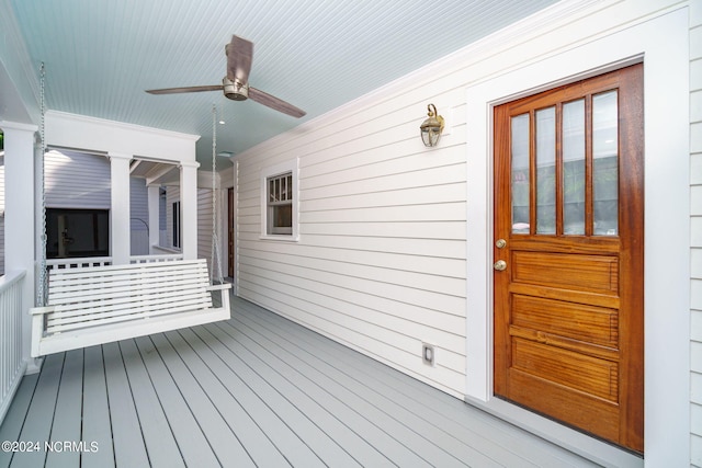 deck with ceiling fan and a porch