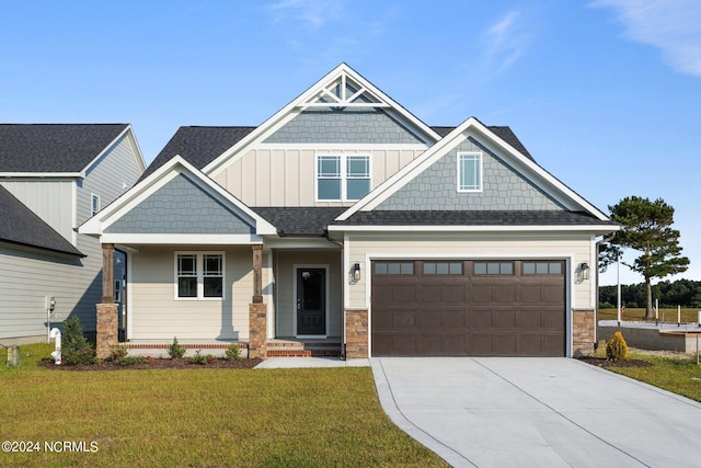 craftsman house with a front lawn and a garage