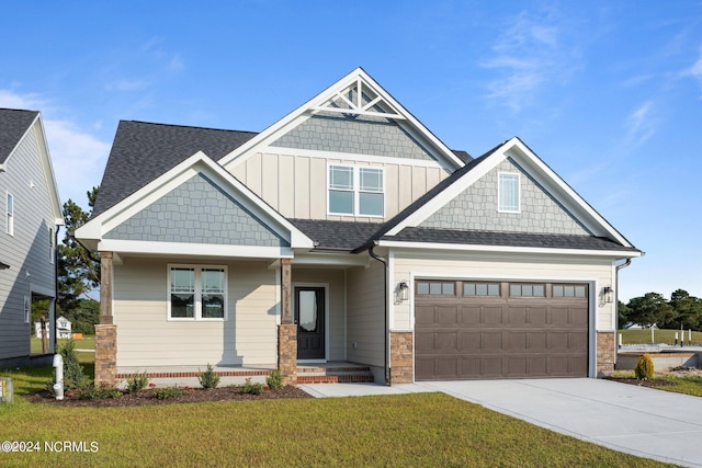 craftsman-style home featuring a front yard and a garage