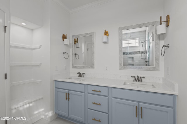 bathroom with tiled shower, crown molding, and vanity