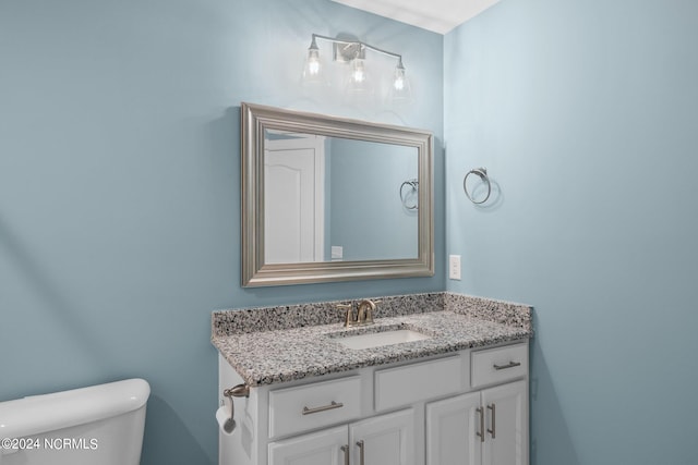 bathroom with toilet and vanity